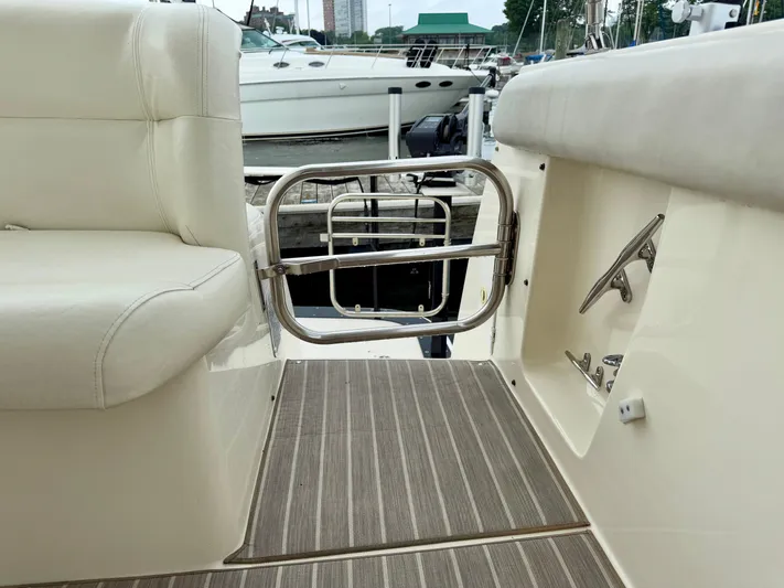  Yacht Photos Pics 2004 Tiara Yachts 4000 Express boat interior with seating and stainless steel gate.