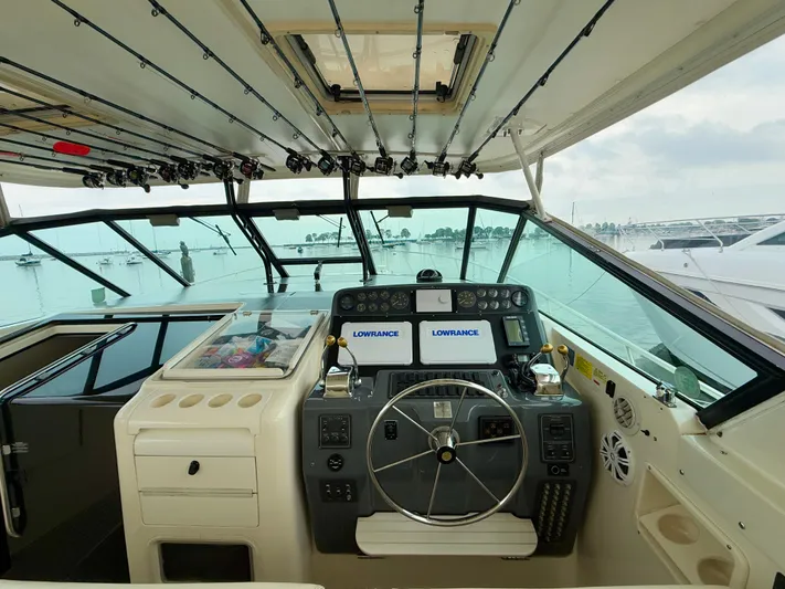  Yacht Photos Pics 2004 Tiara Yachts 4000 Express helm with Lowrance displays and fishing rods.