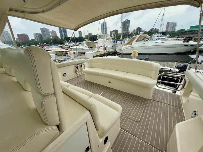  Yacht Photos Pics 2004 Tiara Yachts 4000 Express interior with beige seating, docked in a marina.
