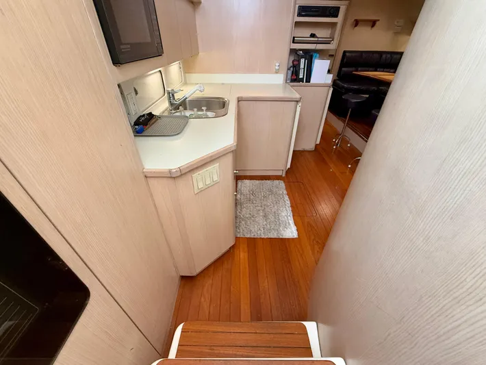  Yacht Photos Pics 2004 Tiara Yachts 4000 Express interior with kitchenette and wooden flooring.