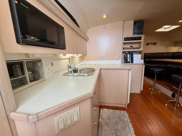  Yacht Photos Pics 2004 Tiara Yachts 4000 Express interior with kitchen, sink, and seating area.