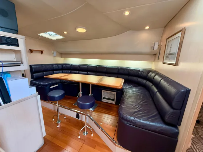  Yacht Photos Pics Luxurious 2004 Tiara Yachts 4000 Express interior with leather seating and wooden flooring.