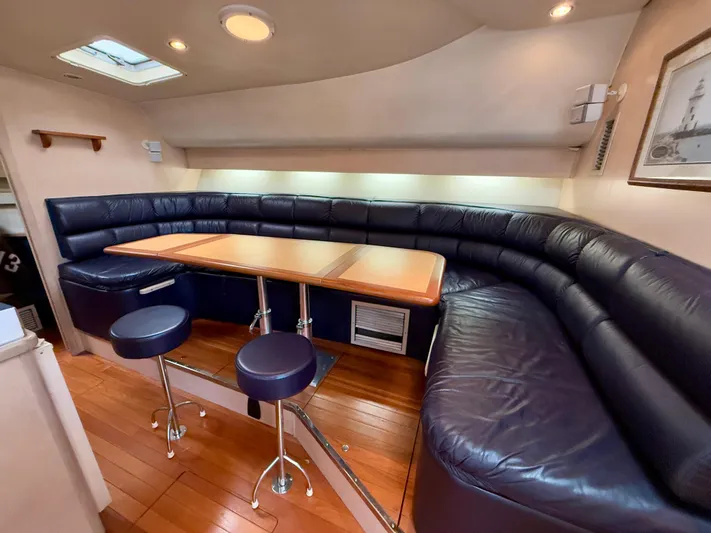  Yacht Photos Pics 2004 Tiara Yachts 4000 Express interior with leather seating and wooden table.