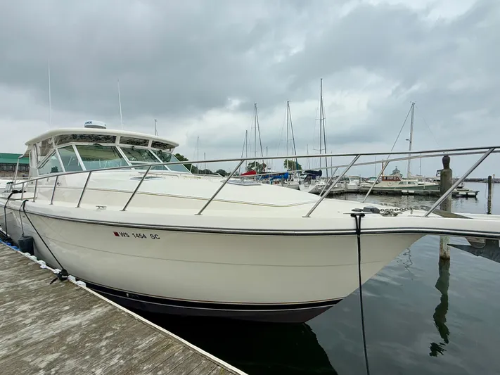  Yacht Photos Pics 1994 Tiara Yachts 4000 Express docked at marina under cloudy sky.