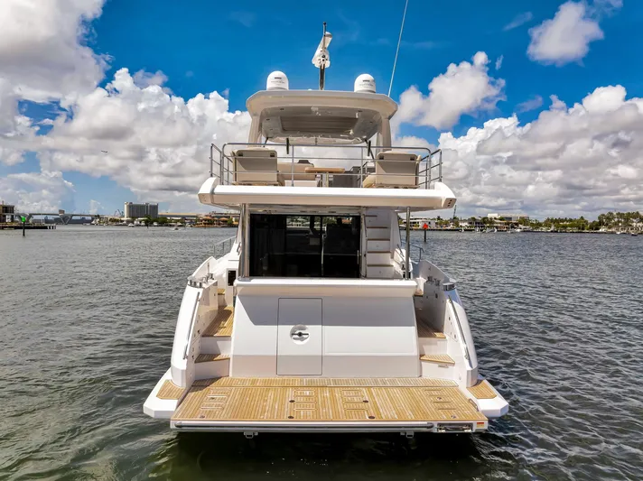  Yacht Photos Pics Azimut Fly 60 yacht, 2022 model, rear view on water under blue sky.