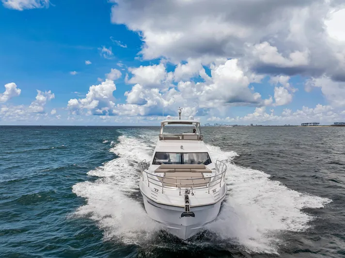  Yacht Photos Pics Azimut Fly 60 yacht cruising on open sea under cloudy sky, 2022 model.