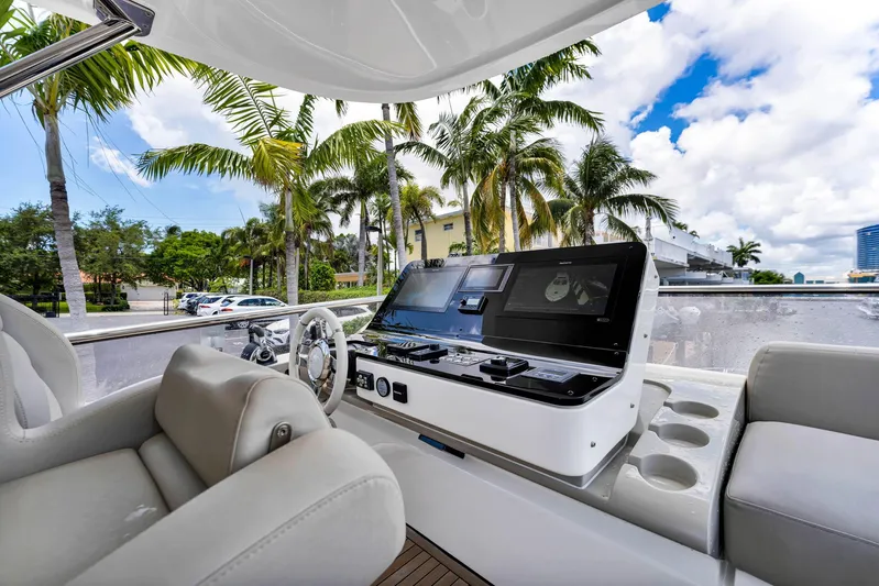  Yacht Photos Pics Interior view of 2022 Azimut Fly 60 yacht with modern helm and palm trees outside.