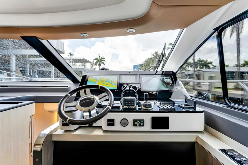  Yacht Photos Pics Helm of 2022 Azimut Fly 60 yacht with modern navigation equipment and steering wheel.