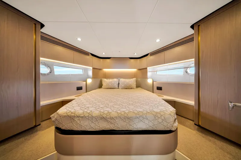  Yacht Photos Pics Luxurious bedroom interior of 2022 Azimut Fly 60 yacht with modern design and ambient lighting.