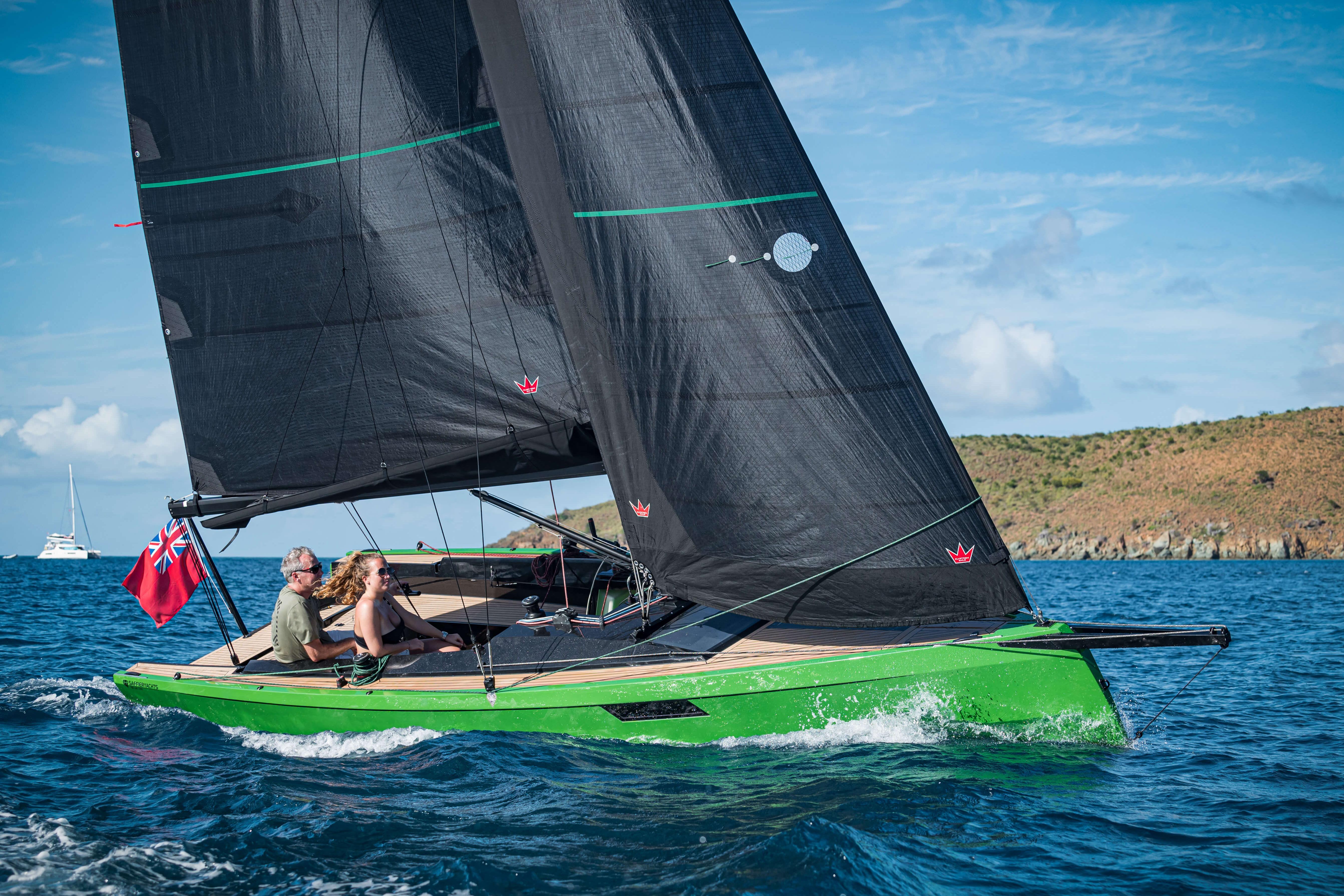 2026 Saffier SE24 Lite sailboat with black sails and green hull on open water.