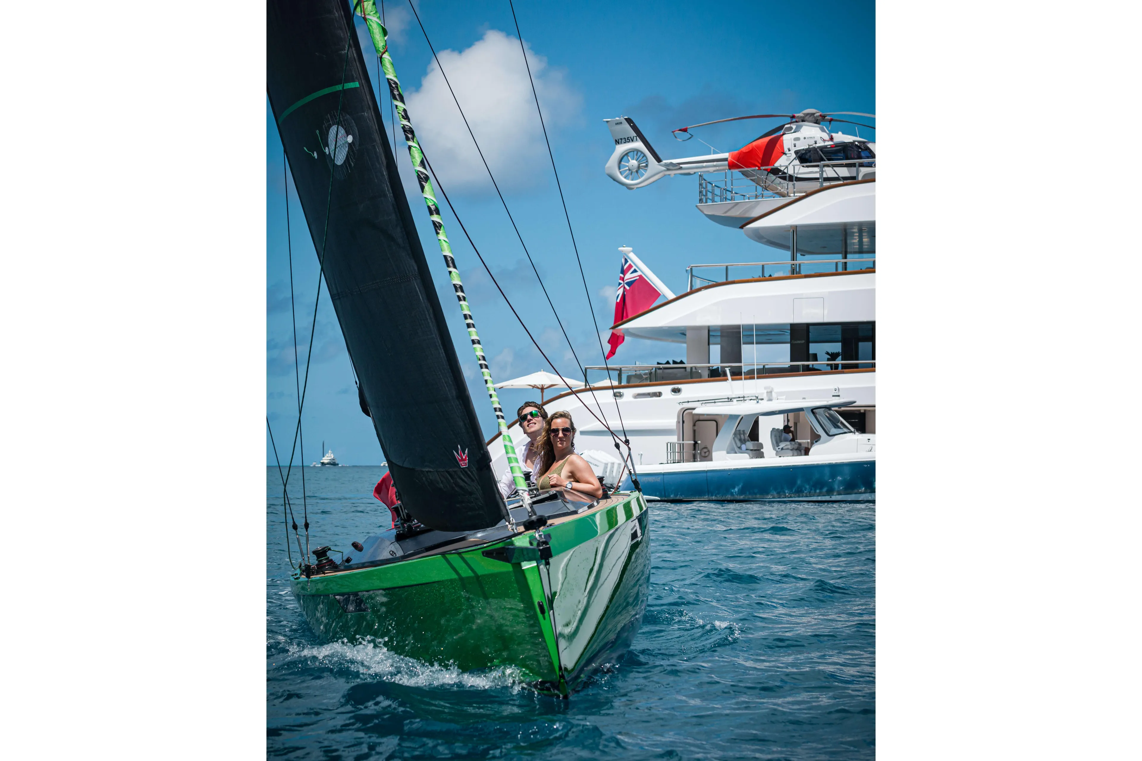 Saffier SE24 Lite 2026 sailing near luxury yacht and helicopter on blue ocean.