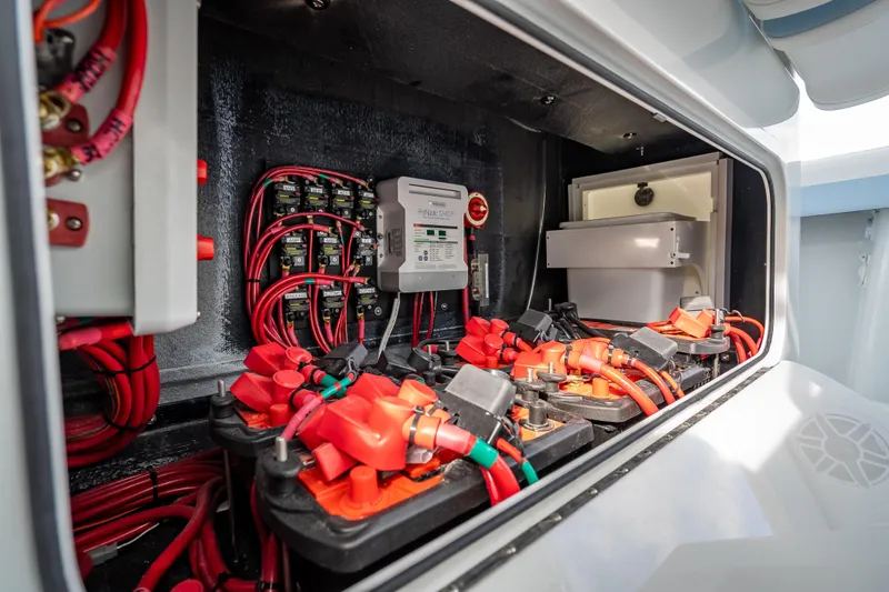 New Stock 42 Offshore Yacht Photos Pics Electrical system of 2026 Yellowfin 42 Offshore boat, featuring red wiring and battery setup.