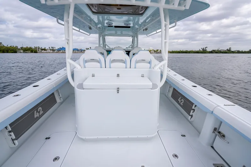 New Stock 42 Offshore Yacht Photos Pics 2026 Yellowfin 42 Offshore boat interior with seating, on calm water.