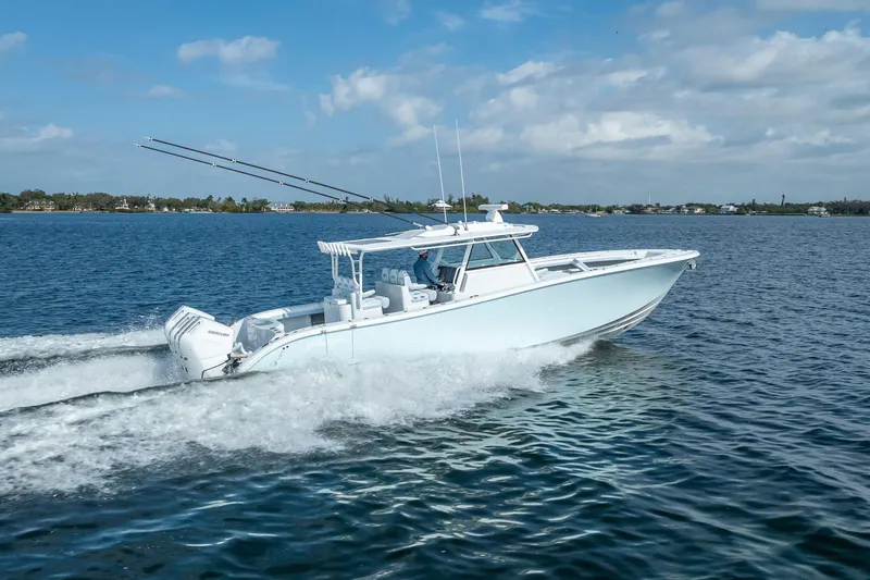 New Stock 42 Offshore Yacht Photos Pics 2026 Yellowfin 42 Offshore boat cruising on open water under a clear sky.