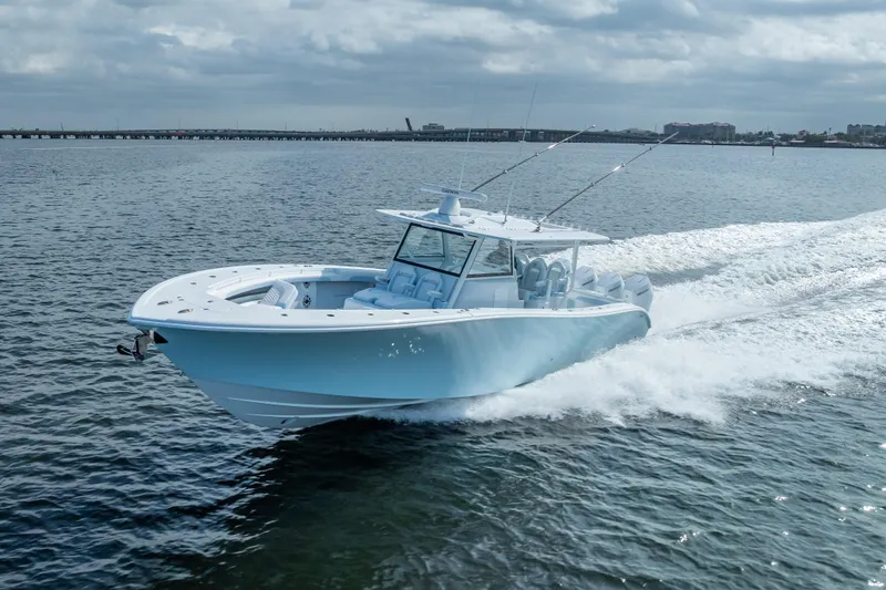 New Stock 42 Offshore Yacht Photos Pics 2026 Yellowfin 42 Offshore boat cruising on open water under cloudy skies.