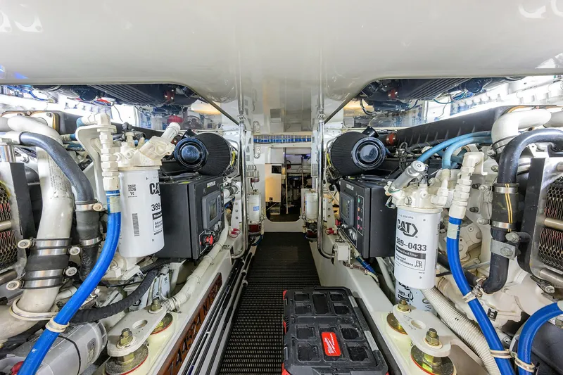 Reelin N Dealin Yacht Photos Pics Engine room of 2013 Hatteras GT63 yacht, showcasing dual Caterpillar engines and mechanical components.
