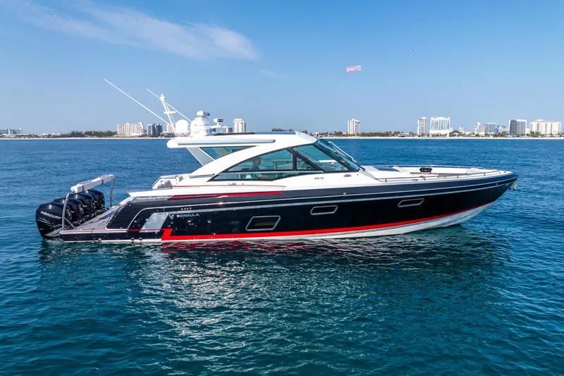  Yacht Photos Pics 2017 Formula 430 All Sport Crossover yacht on blue ocean with city skyline in background.