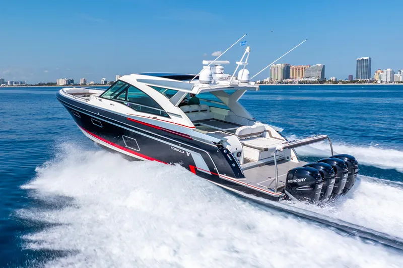  Yacht Photos Pics 2017 Formula 430 All Sport Crossover boat cruising on open water, city skyline in background.
