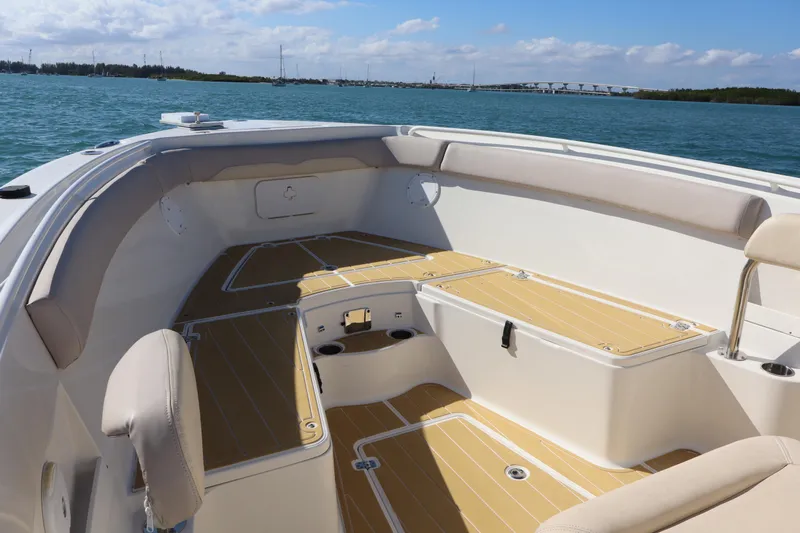  Yacht Photos Pics 2017 Sailfish 320 CC boat interior with cushioned seating and ocean view.