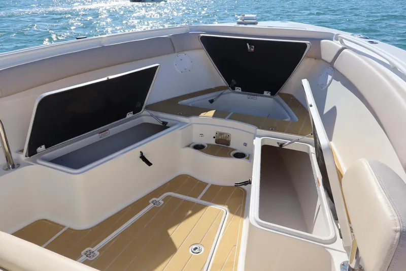  Yacht Photos Pics 2017 Sailfish 320 CC boat interior with open storage compartments on the water.