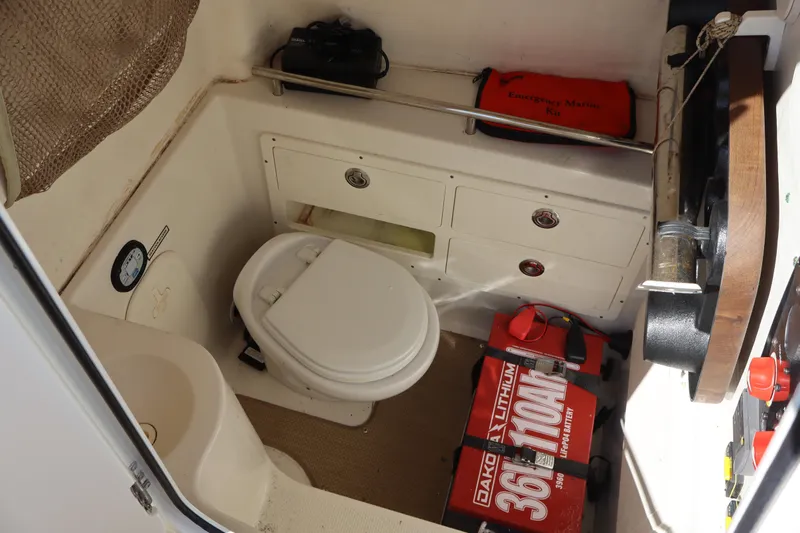  Yacht Photos Pics 2017 Sailfish 320 CC boat interior with marine toilet and emergency kit.