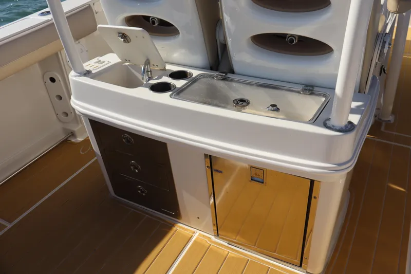  Yacht Photos Pics 2017 Sailfish 320 CC boat interior with sink, storage drawers, and stainless steel features.