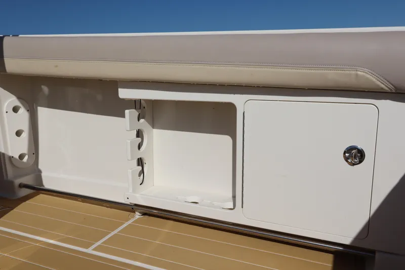  Yacht Photos Pics 2017 Sailfish 320 CC boat storage compartment with beige cushioned seating.