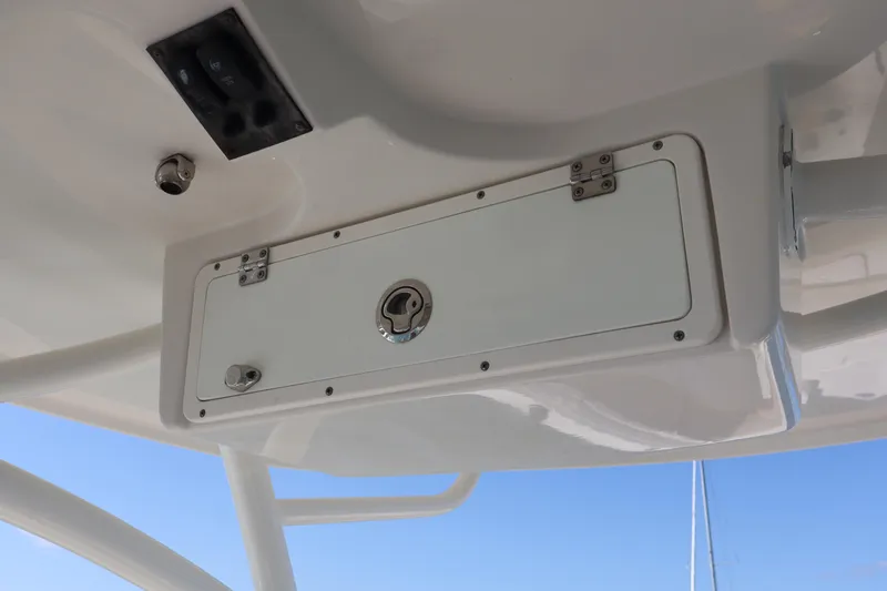  Yacht Photos Pics 2017 Sailfish 320 CC boat storage compartment with latch and hinges, viewed from below.