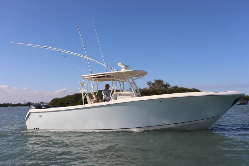  Yacht Photos Pics 2017 Sailfish 320 CC boat cruising on a sunny day with clear blue skies.