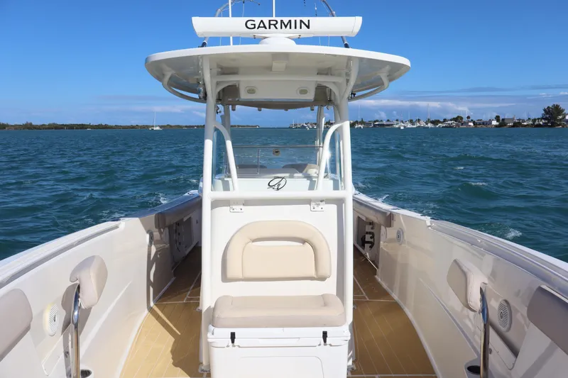  Yacht Photos Pics 2017 Sailfish 320 CC boat on water, featuring Garmin equipment, clear skies, and coastal view.