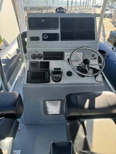  Yacht Photos Pics 2022 Allmand 31 RIB boat dashboard with steering wheel and navigation controls.