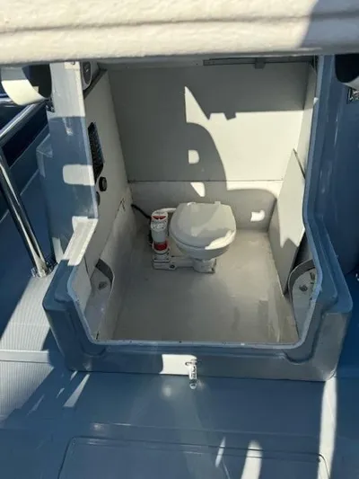  Yacht Photos Pics 2022 Allmand 31 RIB boat interior with compact marine toilet.