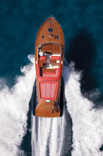  Yacht Photos Pics Aerial view of 2026 J Craft Torpedo 42 luxury boat cruising on blue water.