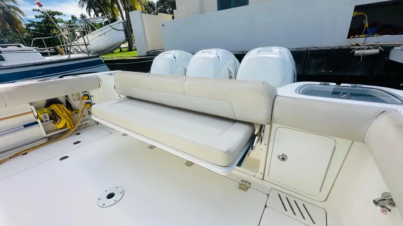  Yacht Photos Pics 2018 Boston Whaler 345 Conquest boat with cushioned seating and triple outboard engines.