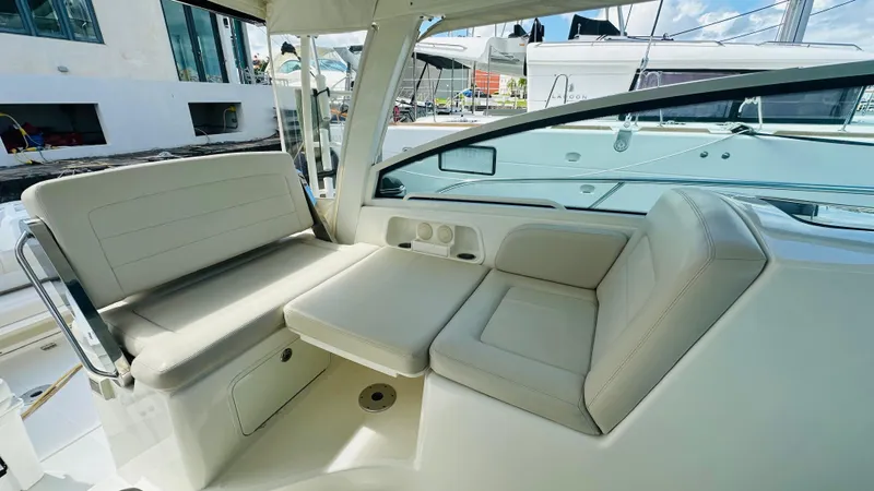  Yacht Photos Pics 2018 Boston Whaler 345 Conquest interior seating area with beige upholstery and modern design.