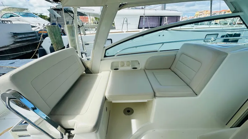  Yacht Photos Pics 2018 Boston Whaler 345 Conquest interior seating area with cushioned benches and sleek design.
