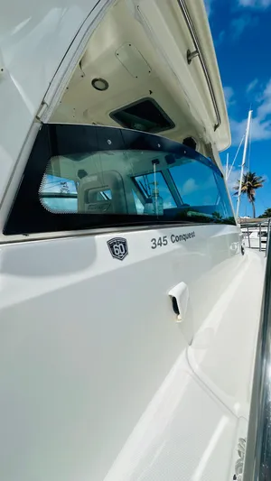  Yacht Photos Pics 2018 Boston Whaler 345 Conquest boat, sleek design, docked under clear blue sky.