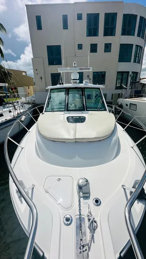  Yacht Photos Pics 2018 Boston Whaler 345 Conquest docked near modern building.