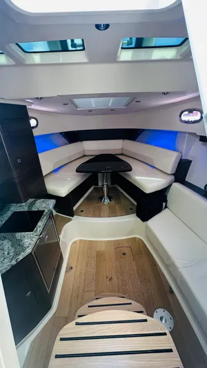  Yacht Photos Pics 2018 Boston Whaler 345 Conquest cabin interior with seating and table.