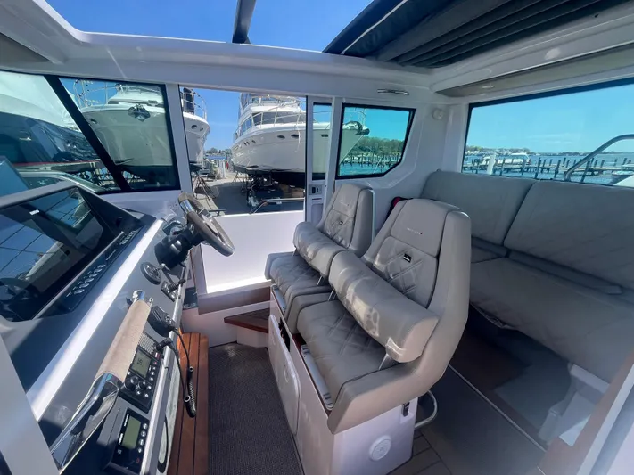  Yacht Photos Pics Interior of 2022 Axopar 28 CABIN boat with modern seating and dashboard.