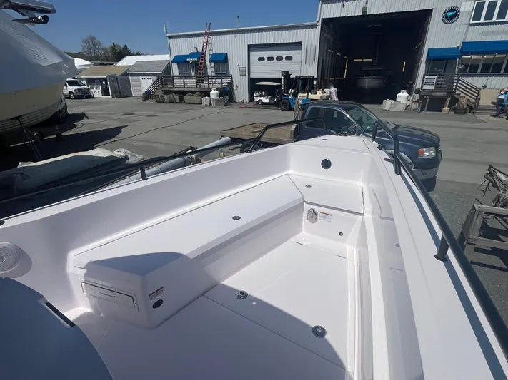  Yacht Photos Pics 2022 Axopar 28 CABIN boat docked at a marina, showcasing spacious seating area.