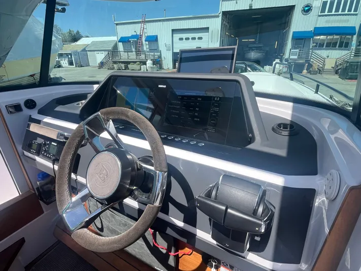  Yacht Photos Pics 2022 Axopar 28 CABIN dashboard with steering wheel and navigation display.