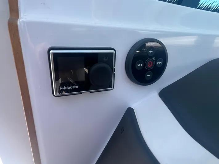  Yacht Photos Pics Control panel on 2022 Axopar 28 CABIN boat featuring Webasto and Fusion systems.