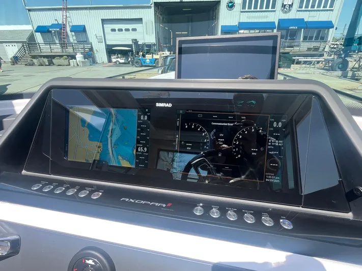  Yacht Photos Pics 2022 Axopar 28 CABIN dashboard with navigation and control displays in a marina setting.