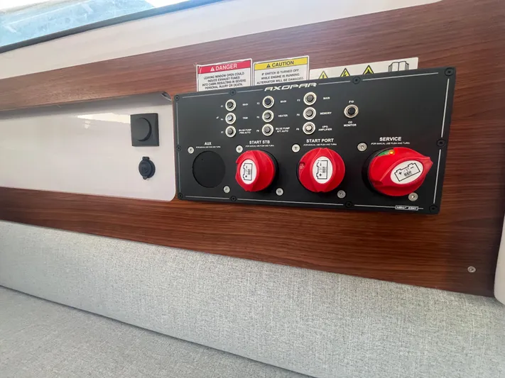  Yacht Photos Pics Control panel of a 2022 Axopar 28 CABIN boat with switches and red knobs.