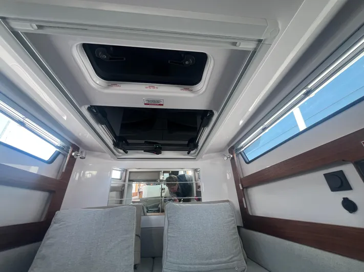  Yacht Photos Pics Interior of 2022 Axopar 28 CABIN with skylight and modern seating.