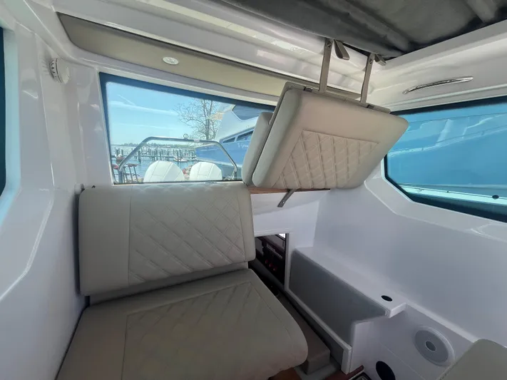  Yacht Photos Pics Interior of 2022 Axopar 28 CABIN boat with seating and windows.