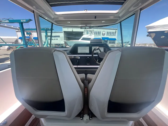  Yacht Photos Pics Interior view of 2022 Axopar 28 CABIN boat with dual seats and dashboard.
