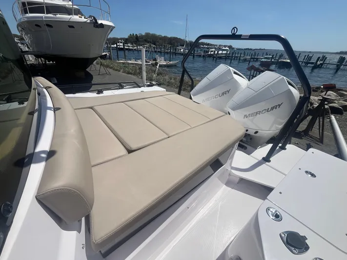  Yacht Photos Pics 2022 Axopar 28 CABIN boat with Mercury engines, docked near a marina.