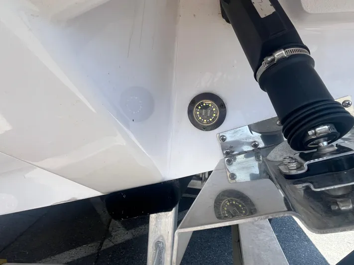  Yacht Photos Pics 2022 Axopar 28 CABIN boat detail showing underwater light and propeller mount.